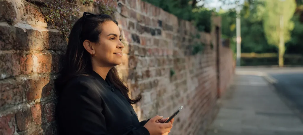Young person using a daily devotional Bible app to pray