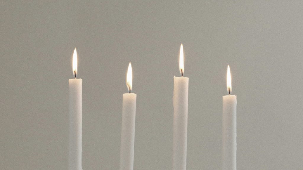 Four white candles representing the four weeks of Advent